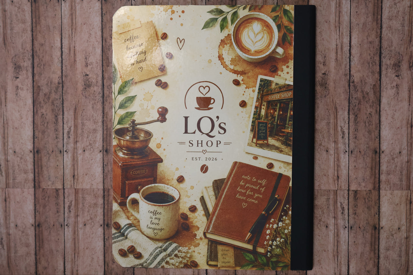 Notebook with coffee-themed cover on a wooden surface