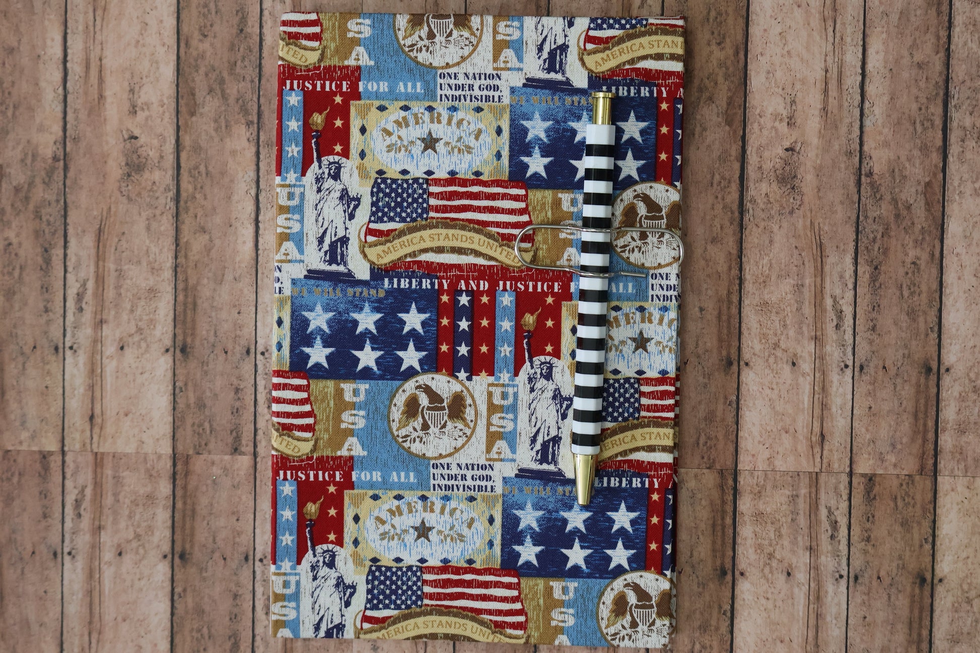 Picture of a notebook with the American bald Eagle, American flag with messages of Justice for all and USA.
