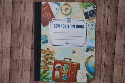 Composition book with travel-themed cover on a wooden surface