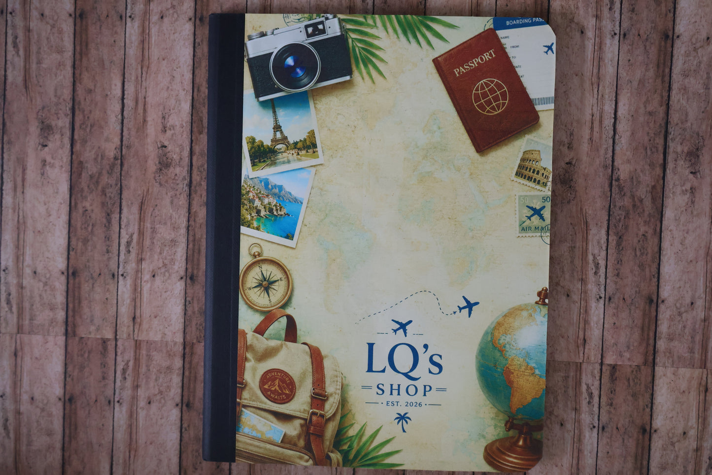 Decorative mouse pad with travel-themed design on a wooden surface